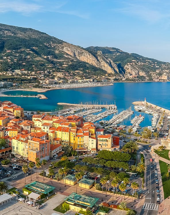 Aerial view of colorful buildings and marina in Menton, French Riviera.