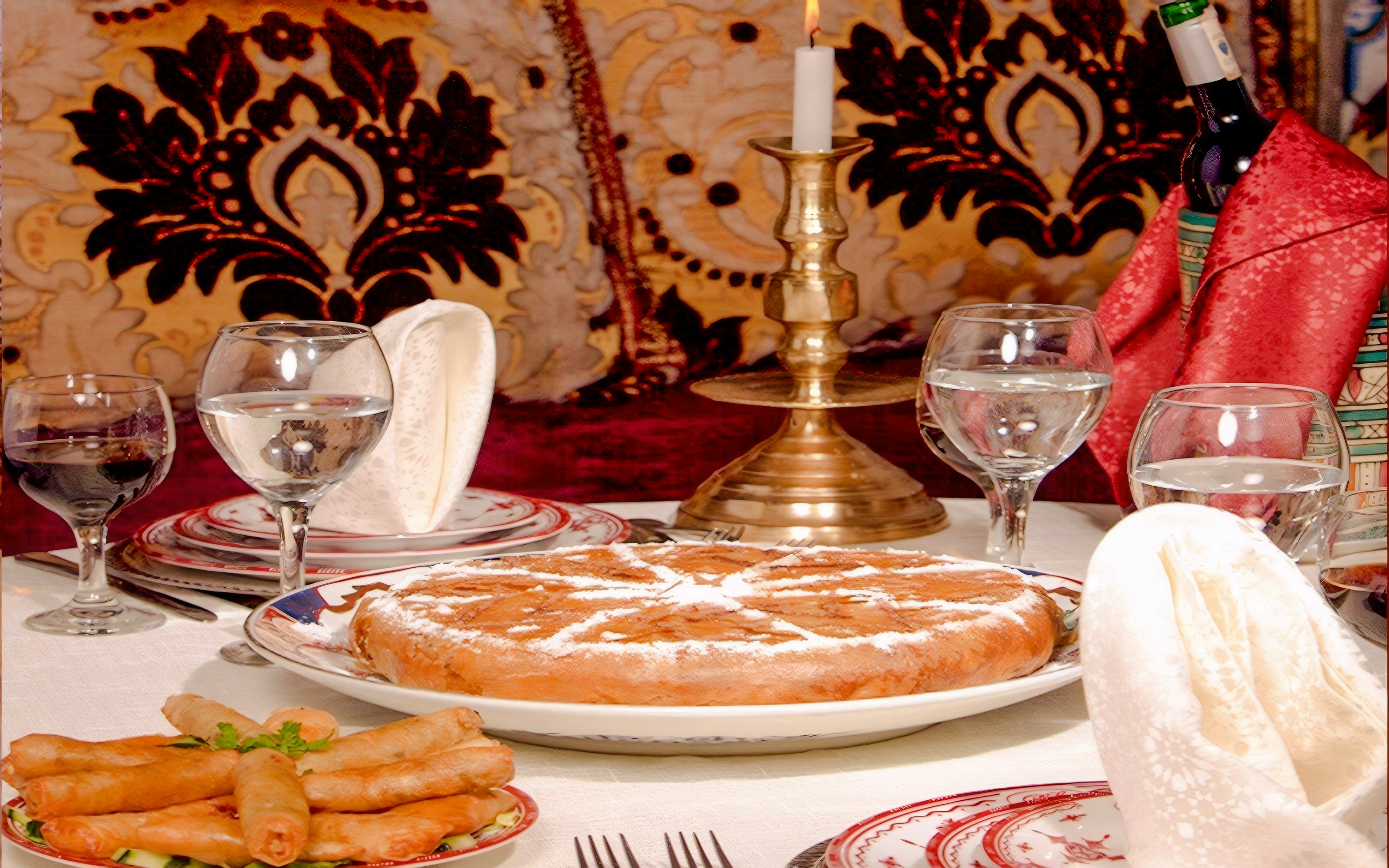 Traditional Moroccan dishes at Dar Essalam Dinner Show with ornate decor.