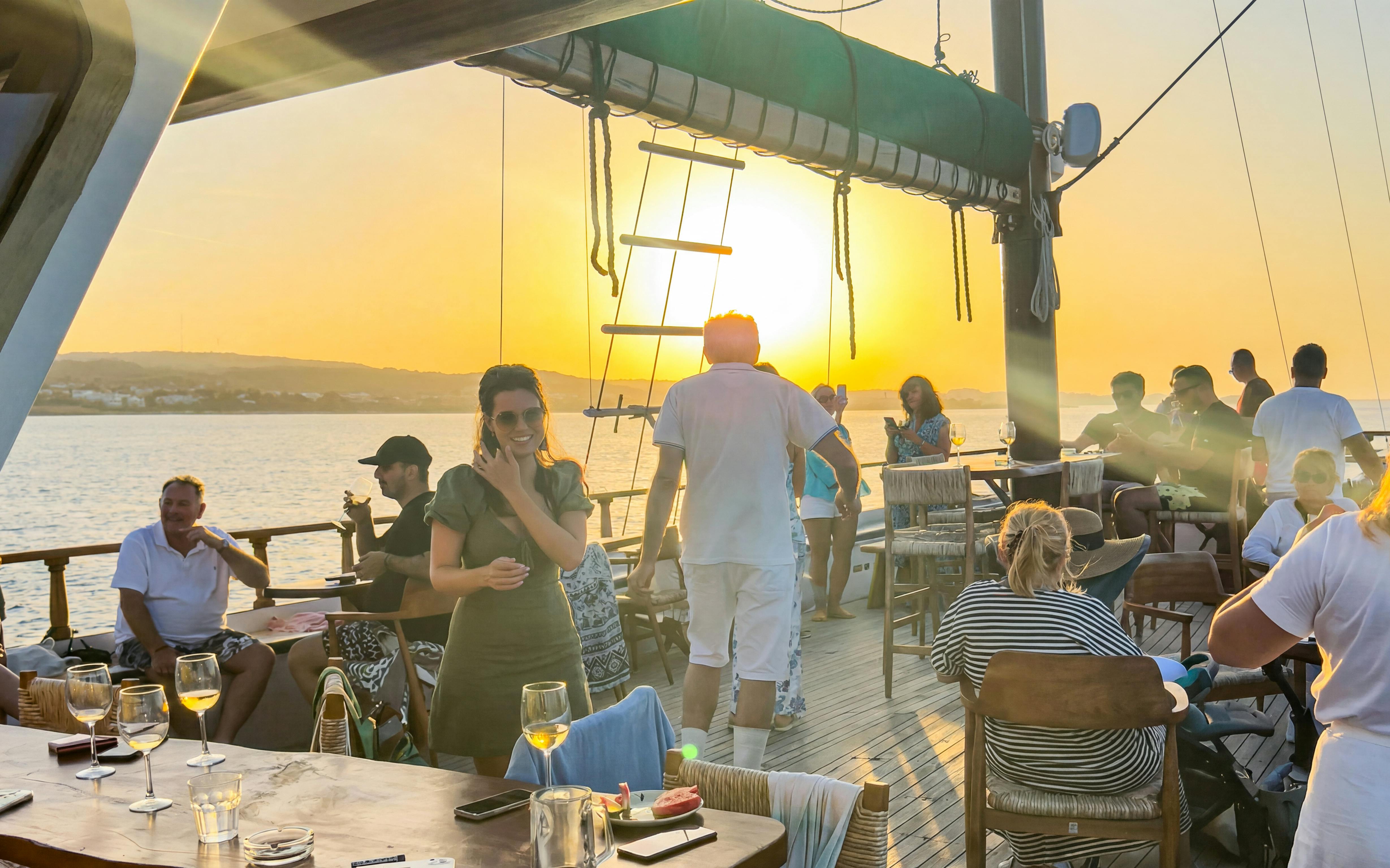 Guests enjoying a sunset cruise on a boat with open bar and buffet near Ayia Napa.