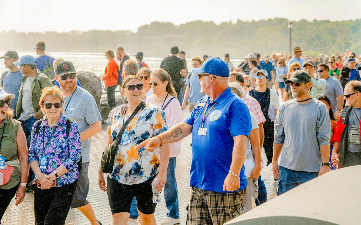 Tour group walking with guide at Niagara Falls, Canada.