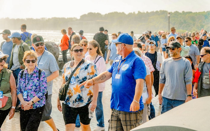 Tour group walking with guide at Niagara Falls, Canada.