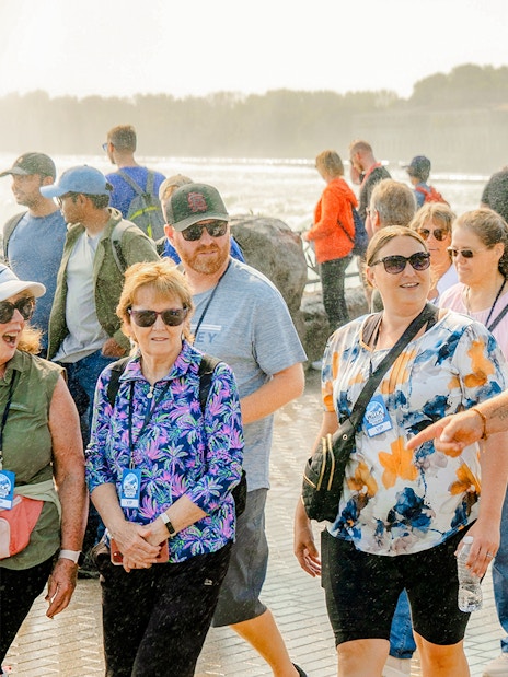 Tour group walking with guide at Niagara Falls, Canada.
