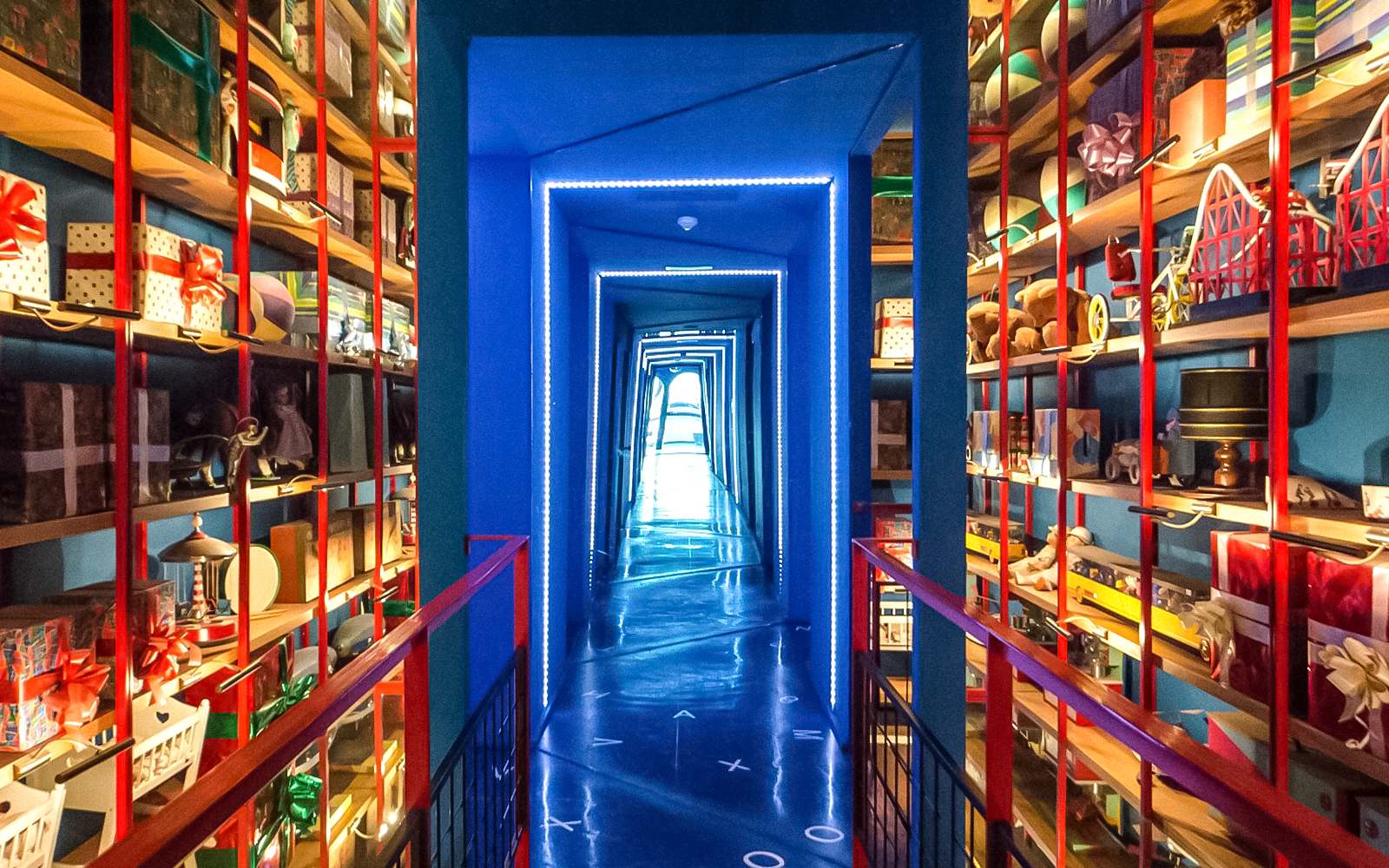 Miramiralls corridor with mirrored walls and colorful shelves at Tibidabo Amusement Park.