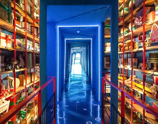 Miramiralls corridor with mirrored walls and colorful shelves at Tibidabo Amusement Park.