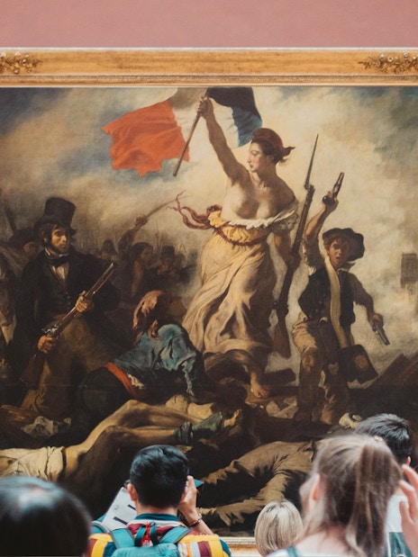 Visitors viewing Eugène Delacroix's "Liberty Leading the People" at the Louvre Museum, Paris.