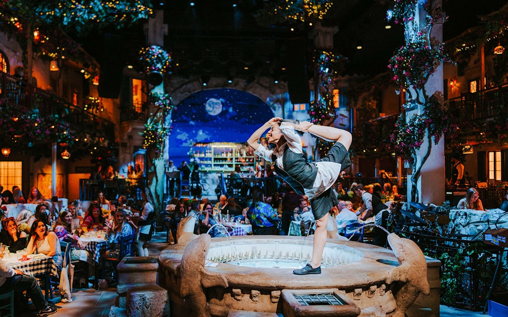 Performer dancing on a fountain at Mamma Mia! The Party event.
