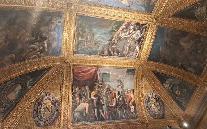 Ceiling frescoes and ornate gold detailing inside the Royal Palace of Naples.