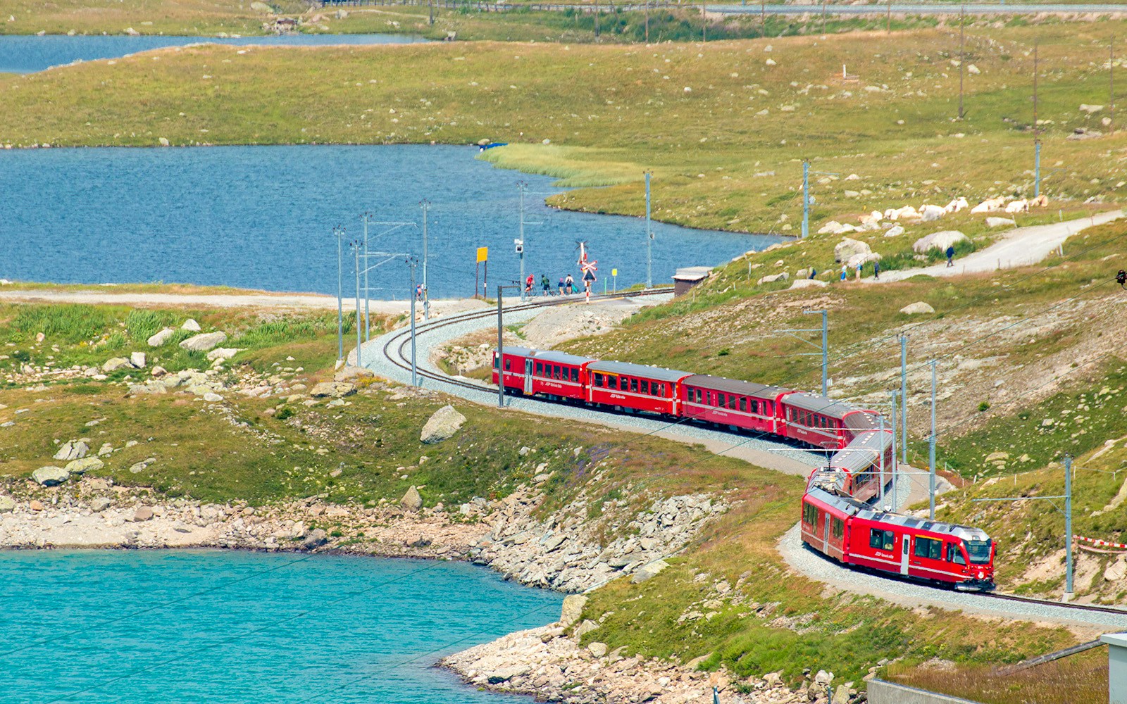 Swiss train in the alps and river around Bernina pass, Engadine, Switzerland