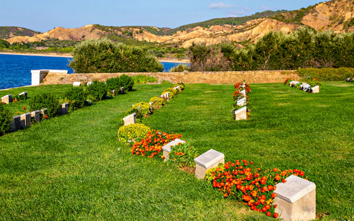 Beach Cemetery at Anzac Cove, Gallipoli, Turkey, with gravestones and flowers.