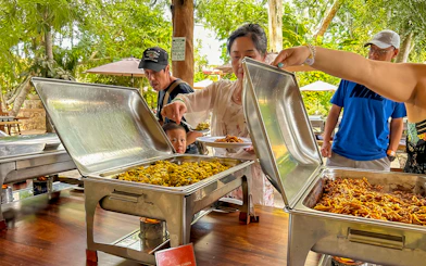 Tourists serving themselves at a buffet lunch during Chichen Itza tour.