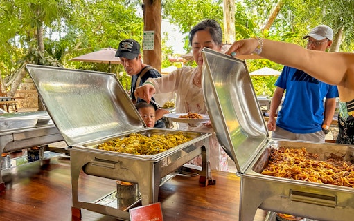 Tourists serving themselves at a buffet lunch during Chichen Itza tour.