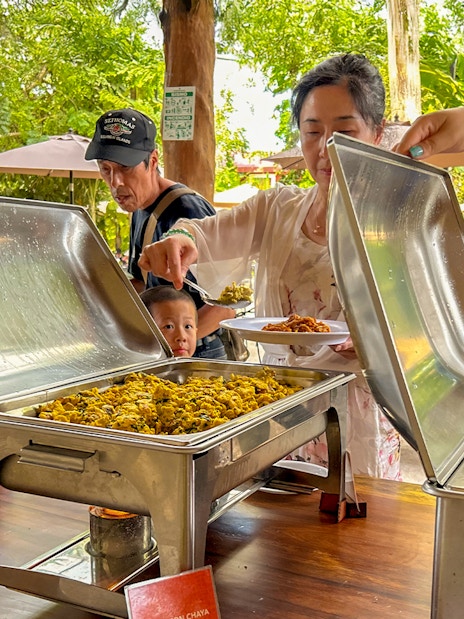 Tourists serving themselves at a buffet lunch during Chichen Itza tour.
