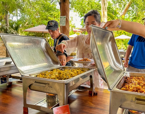 Tourists serving themselves at a buffet lunch during Chichen Itza tour.