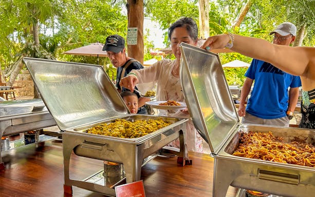 Tourists serving themselves at a buffet lunch during Chichen Itza tour.