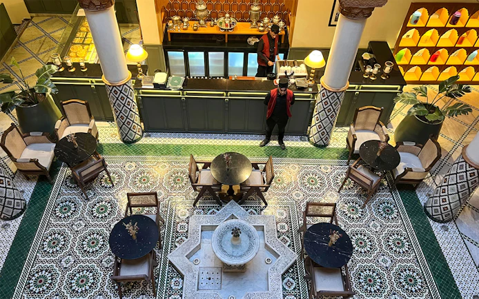 Moroccan Culinary Arts Museum interior with mosaic tiles and traditional seating.