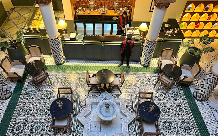 Moroccan Culinary Arts Museum interior with mosaic tiles and traditional seating.