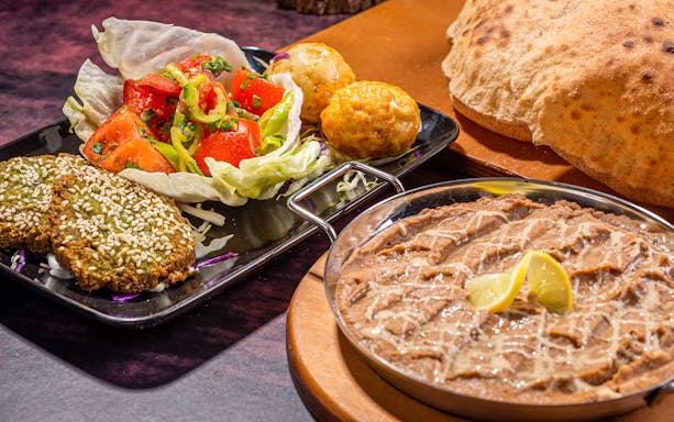 Traditional Egyptian dishes with falafel, salad, and bread in Cairo tour.