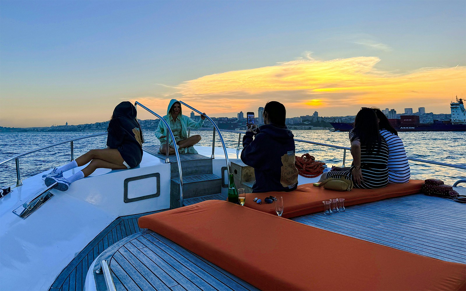 Visitors enjoying a sunset cruise on a private luxury yacht in Dubai.
