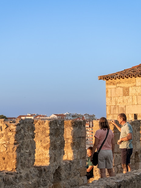 Visitors exploring the ancient walls of St George's Castle in Lisbon.