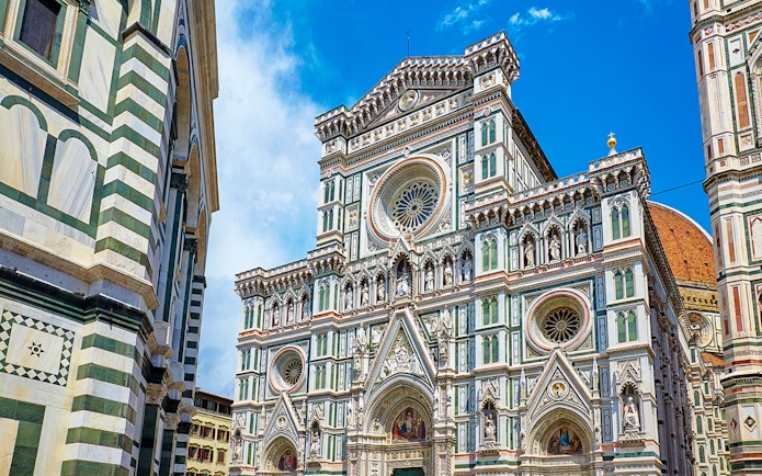 Facade of Florence Cathedral with intricate marble design and rose window.