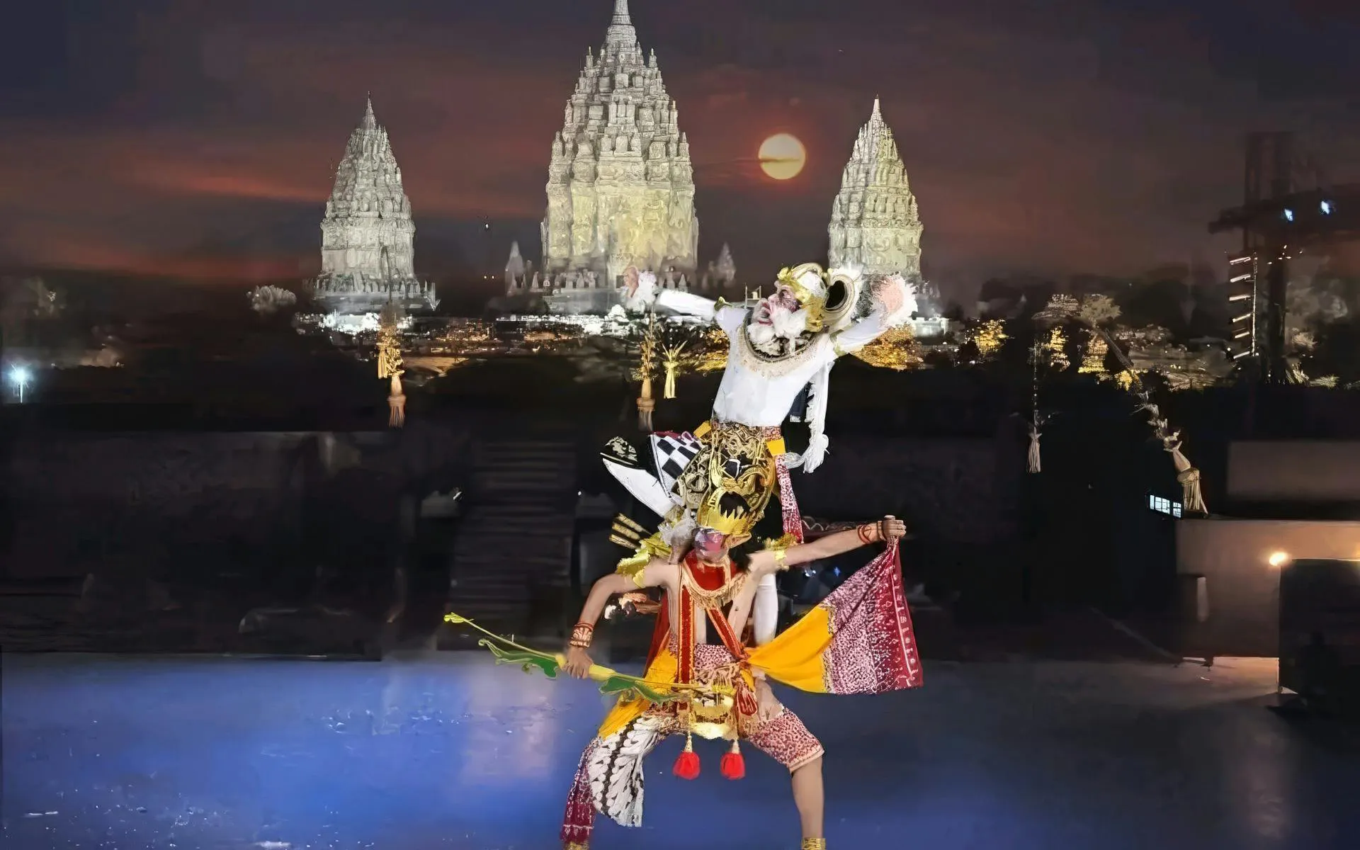 Traditional dance performance at Prambanan Temple, Indonesia, with illuminated temple backdrop.