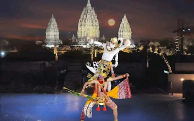 Traditional dance performance at Prambanan Temple, Indonesia, with illuminated temple backdrop.