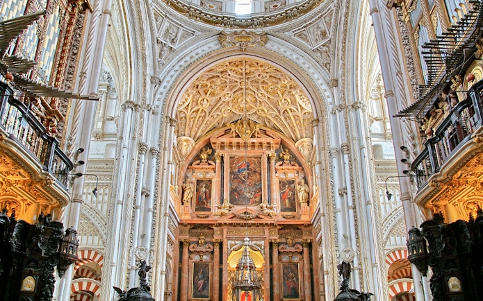 Cordoba Mosque-Cathedral interior with ornate arches and detailed ceiling.