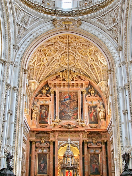 Cordoba Mosque-Cathedral interior with ornate arches and detailed ceiling.