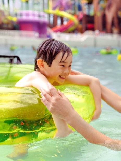 Child and parent enjoying a pool at American Dream DreamWorks Water Park.