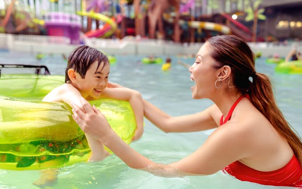Child and parent enjoying a pool at American Dream DreamWorks Water Park.