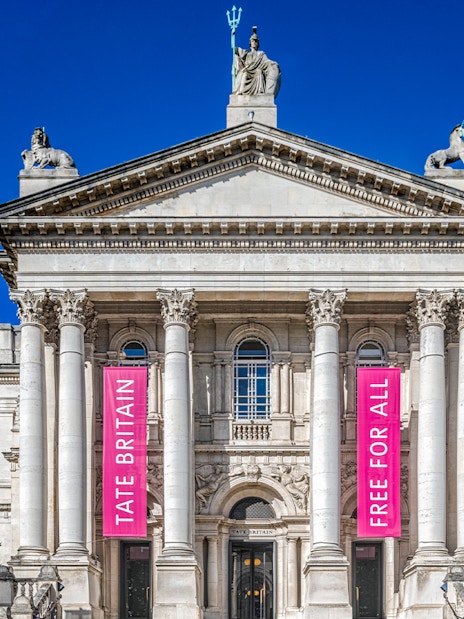 Tate Britain entrance with banners for Edward Burra and Ithell Colquhoun exhibition, London.