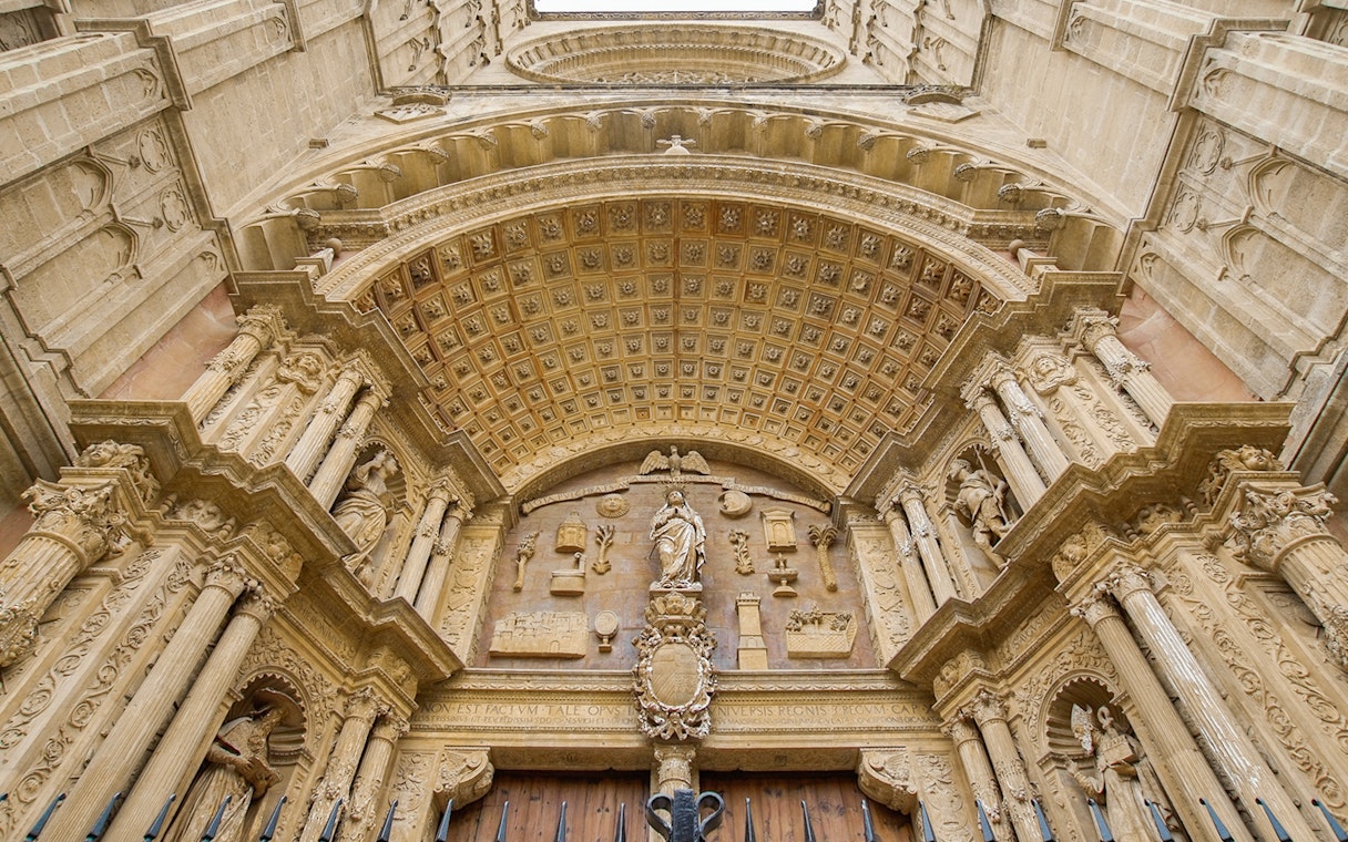 Mallorca Cathedral entrance with ornate carvings and statues.