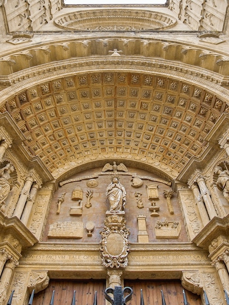 Mallorca Cathedral entrance with ornate carvings and statues.