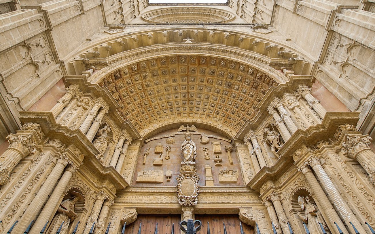 Mallorca Cathedral entrance with ornate carvings and statues.
