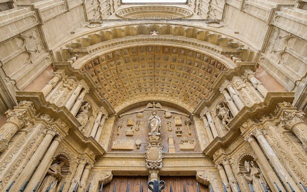 Mallorca Cathedral entrance with ornate carvings and statues.