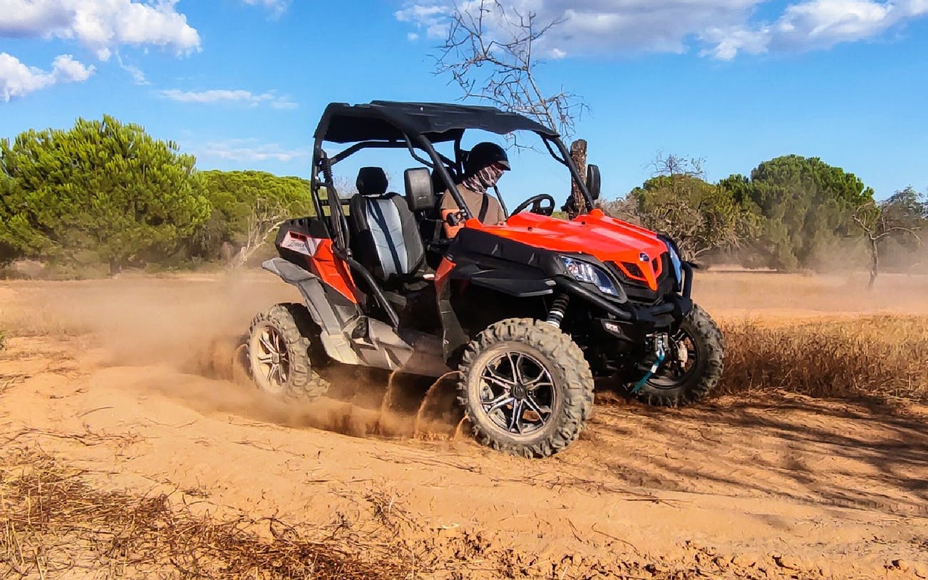 Off-road buggy driving through sandy terrain near Albufeira on a guided tour.