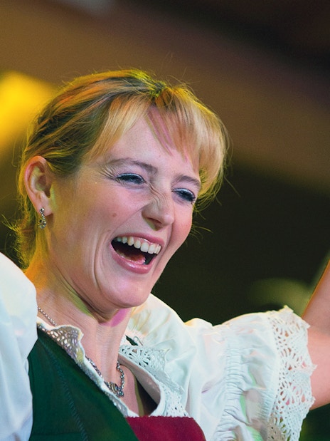 Performer at Tyrolean Evening Folk Show, Austria, holding cowbells.