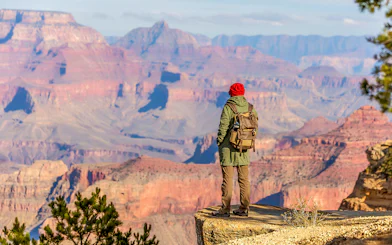Hiker overlooking the Grand Canyon from the South Rim, Arizona, USA.