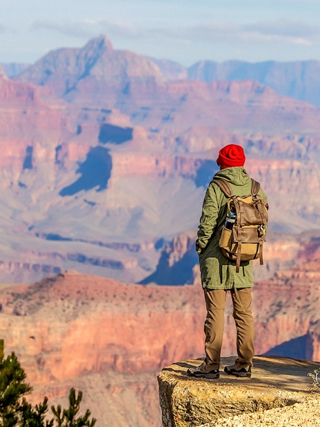 Hiker overlooking the Grand Canyon from the South Rim, Arizona, USA.