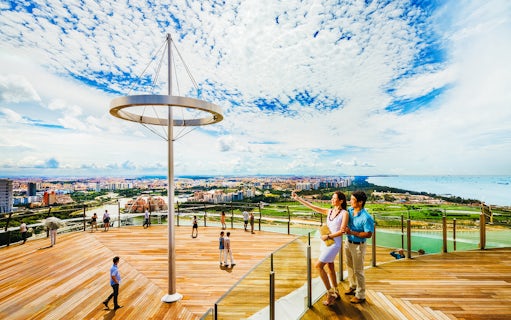 Tourists enjoying the view from Marina Bay Sands SkyPark Observation Deck in Singapore.