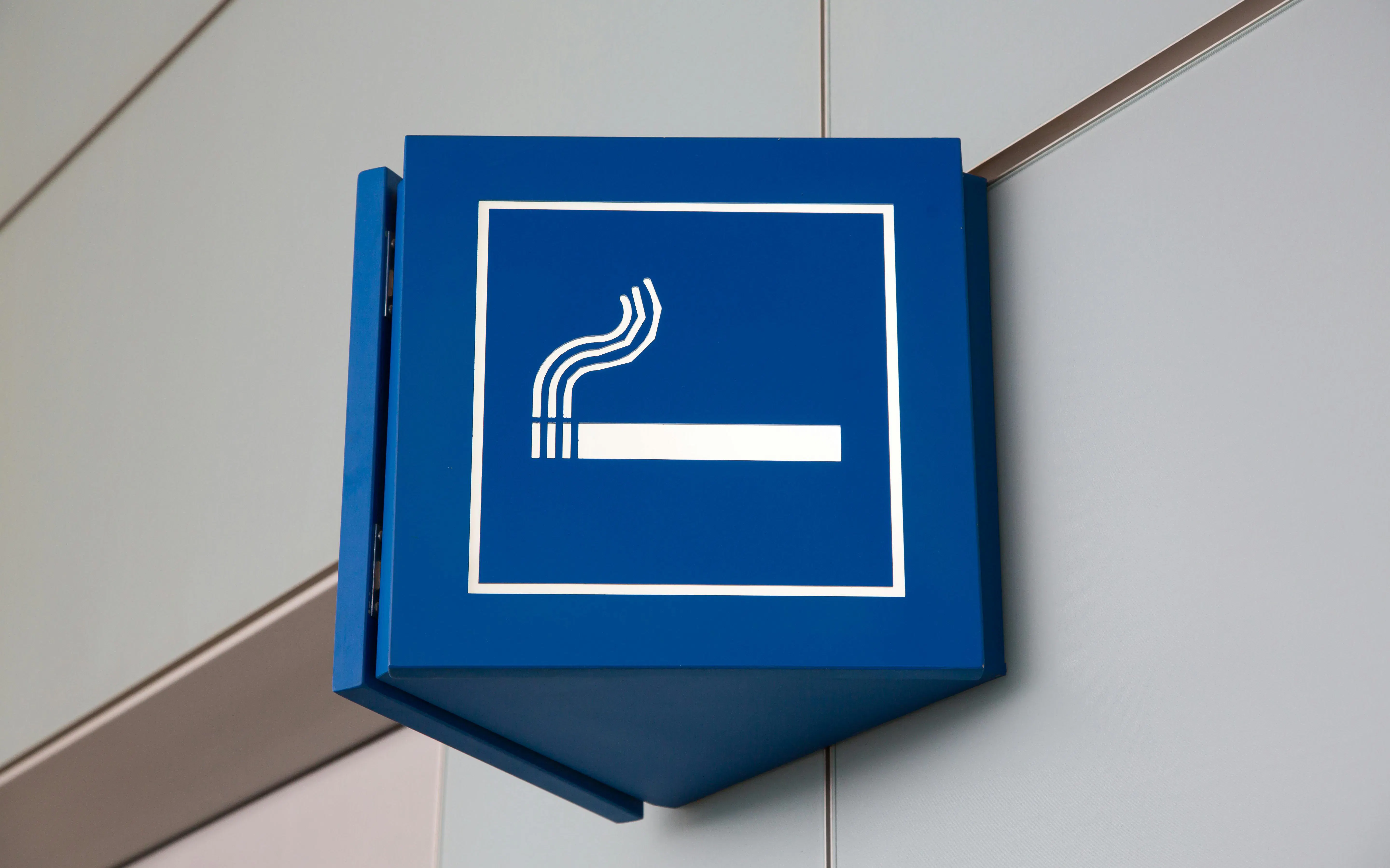Smoking area sign in airport lounge.