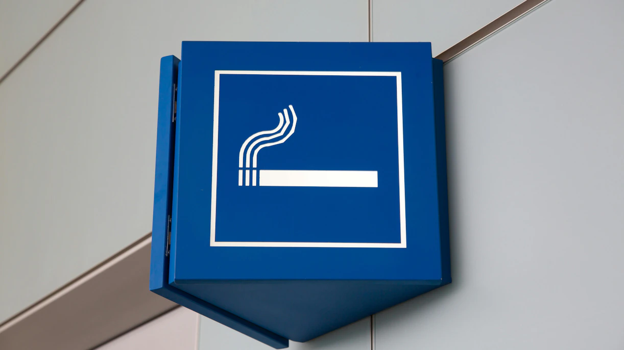 Smoking area sign in airport lounge.