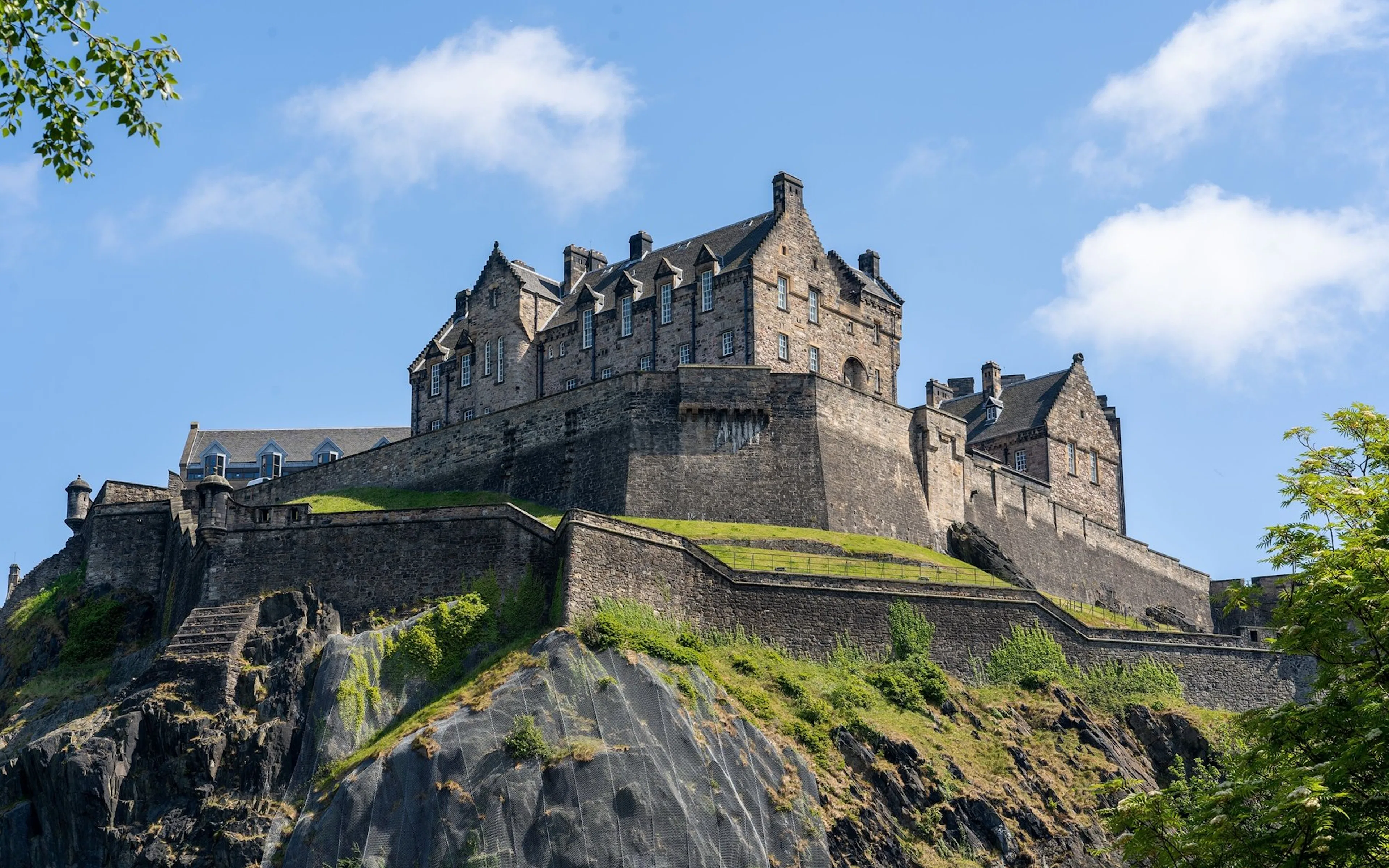 Edinburgh Castle on Castle Rock under a clear blue sky.