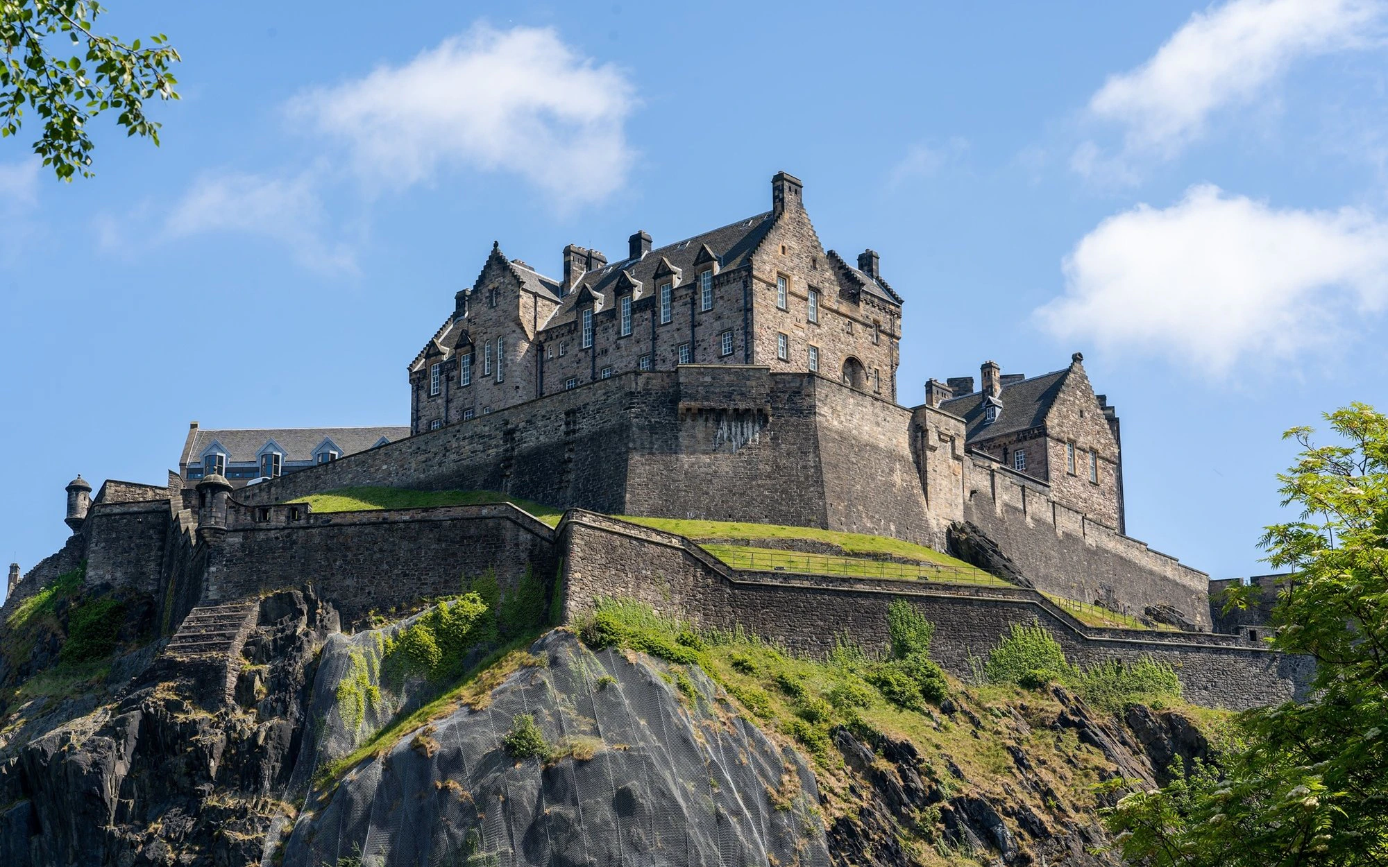 Edinburgh Castle on Castle Rock under a clear blue sky.
