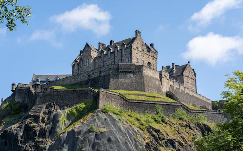 Edinburgh Castle on Castle Rock under a clear blue sky.