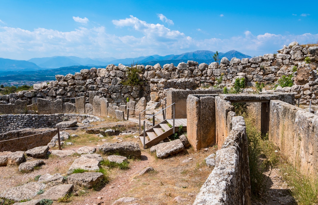 Ancient ruins of Mycenae with stone walls and mountainous backdrop, part of Nafplio-Mycenae-Epidaurus tour.