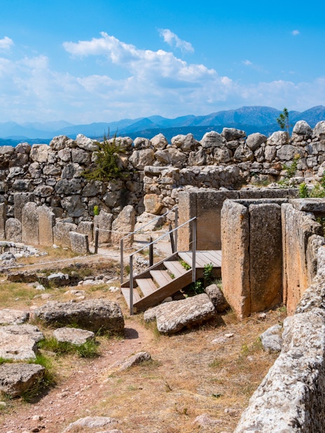 Ancient ruins of Mycenae with stone walls and mountainous backdrop, part of Nafplio-Mycenae-Epidaurus tour.