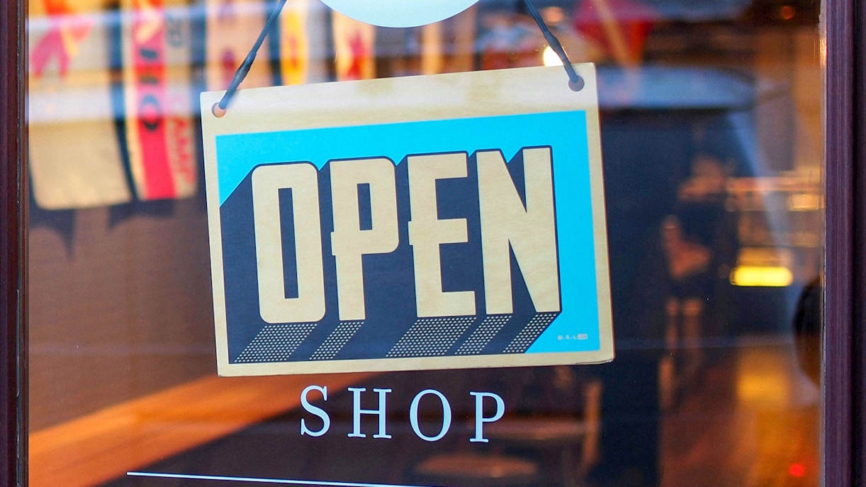 Open sign on shop window in city center