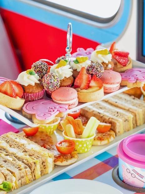Snacks on Peppa Pig themed bus tour with sandwiches, cupcakes, and macarons on Brigit’s Afternoon Tea Bus.