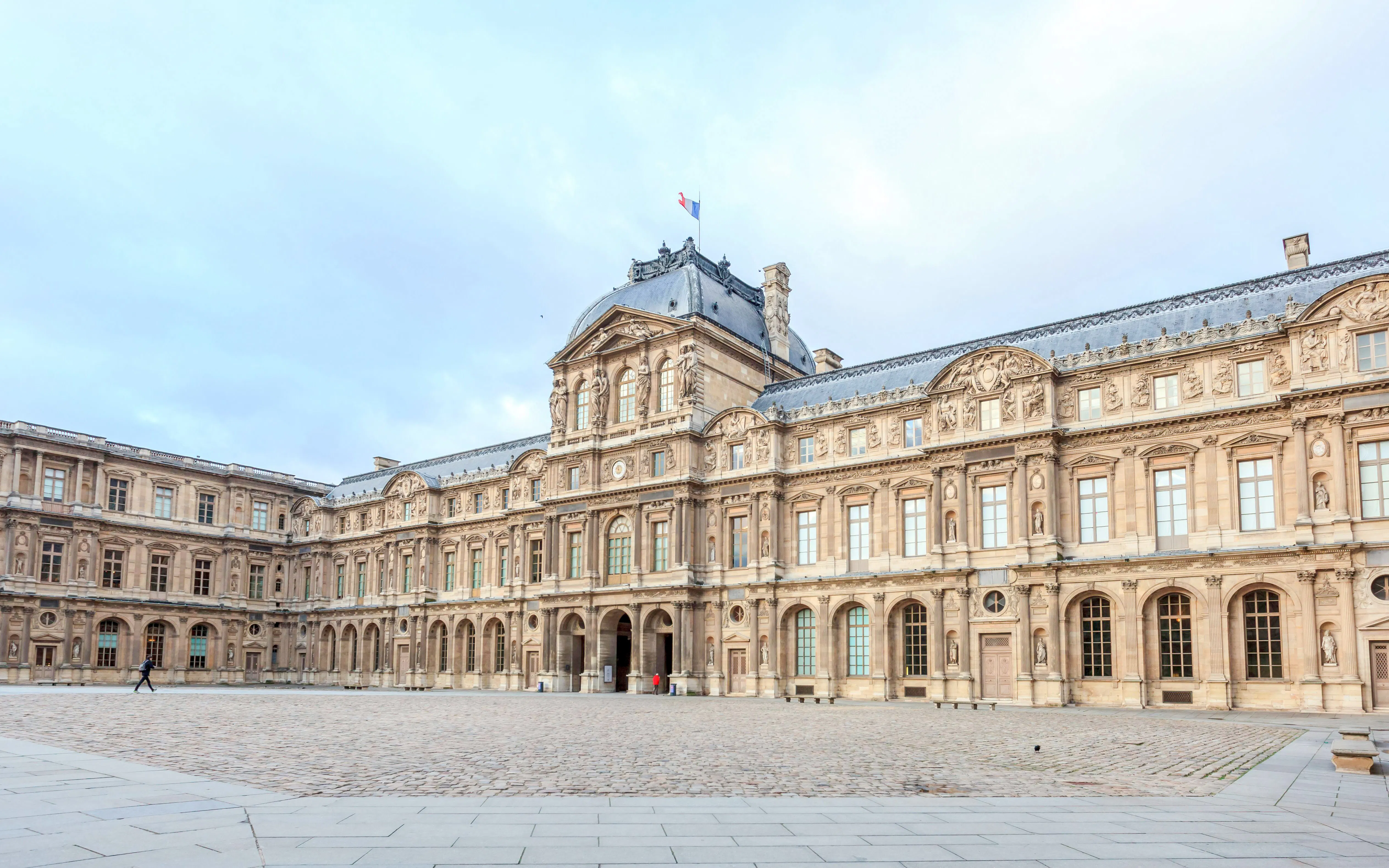 Louvre Museum courtyard in Paris during a walking tour.